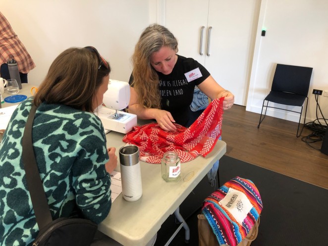A repairer fixes a lamp at a previous Repair Revolution event