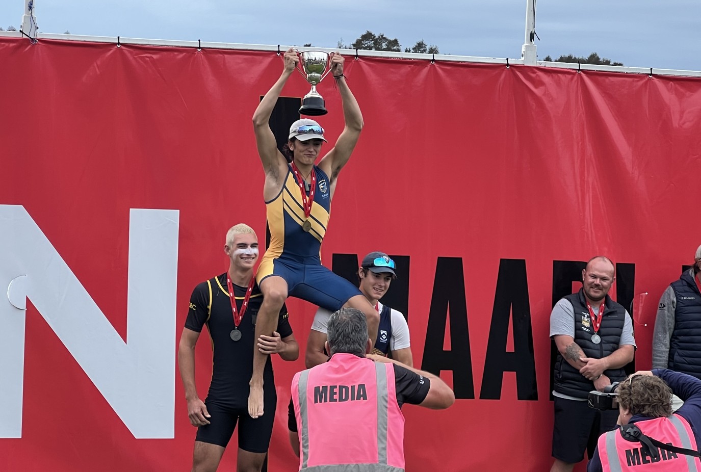 A triumphant Marley King Smith is held high as winner of the U18 Boys Single Sculls at the Maadi Cup at Lake Karapiro at the weekend.