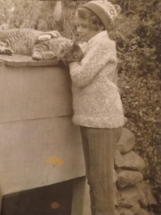 Always a cat lover Julia loving on a stray cat in Weaver Street in the late 1960s
