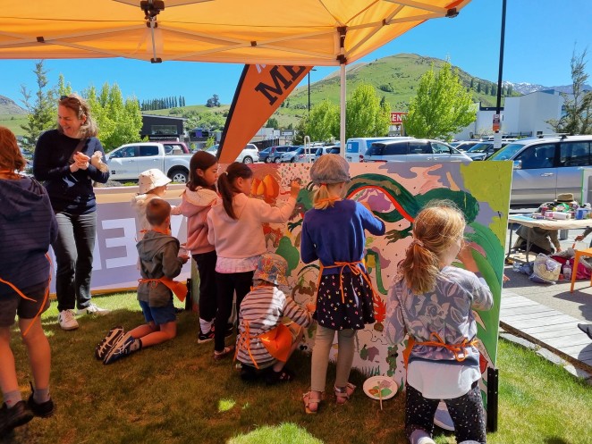 Children painting the mural at Saturday event