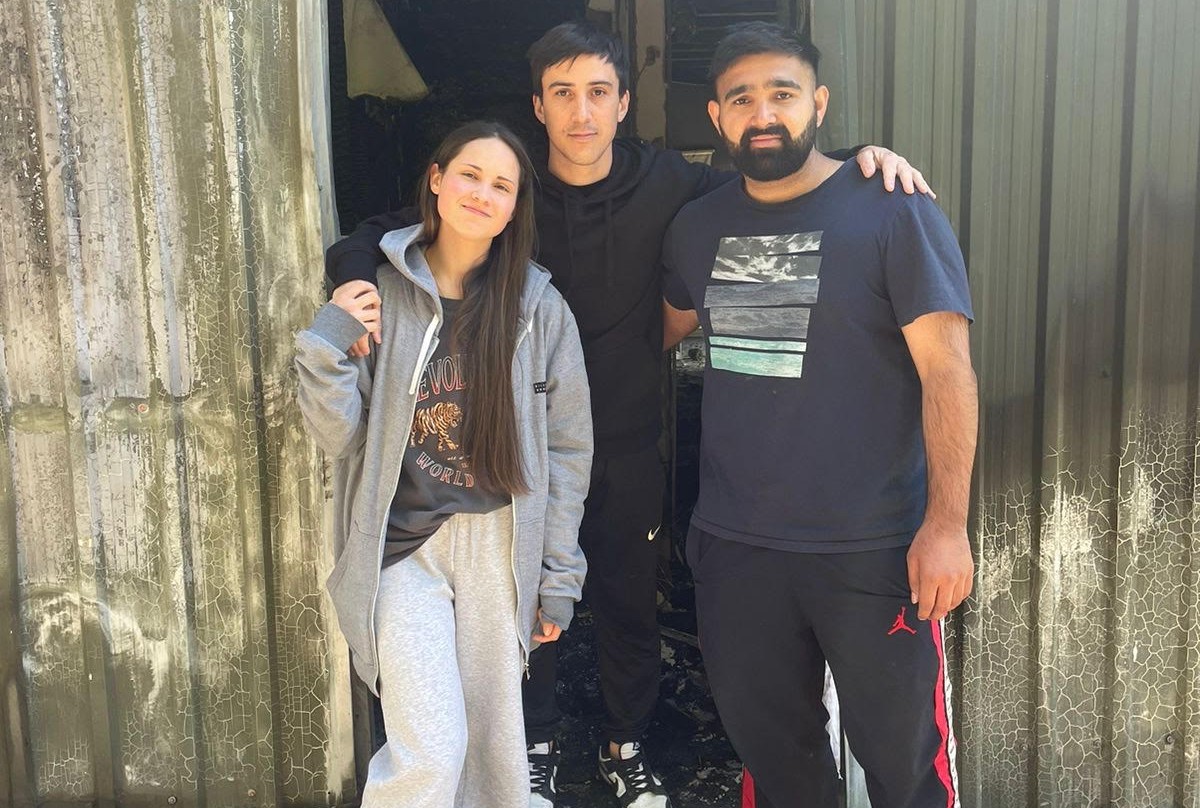 Devastated flatmatesJ from leftJ Maia Holz and Carlos ZanlungoJ both from South AmerciaJ and Indian Sandeep Dahiya outside the ruins of their Lower Shotover home