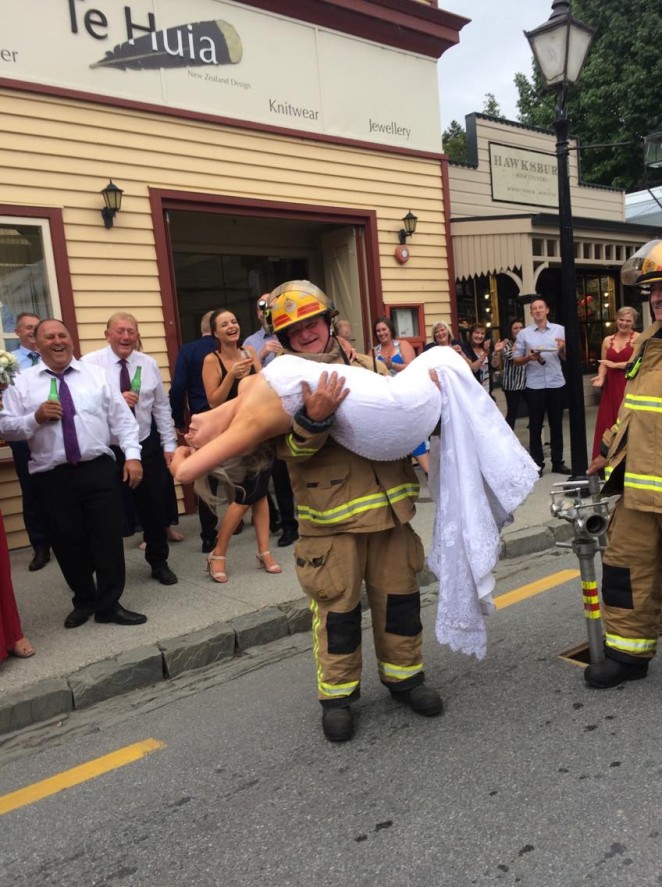 GarryJ carrying local bride Kelsi out of the Arrowtown Athenaeum Hall for a laugh after the brigade interrupted wedding celebrations for a call out to the hall in 2008