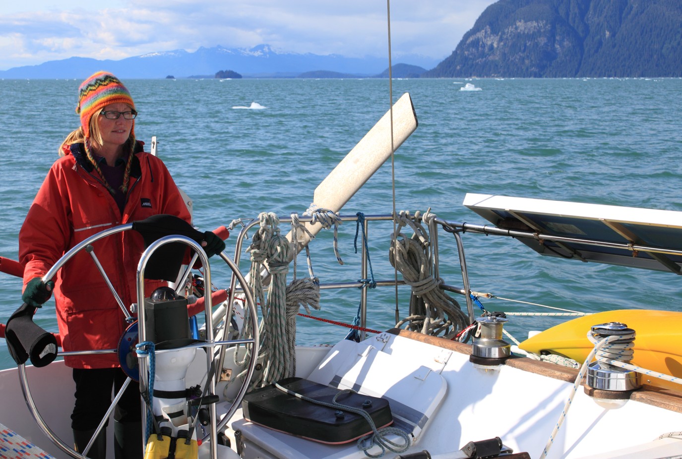 Helen at the helm on an Alaskan summer sailing adventure copy