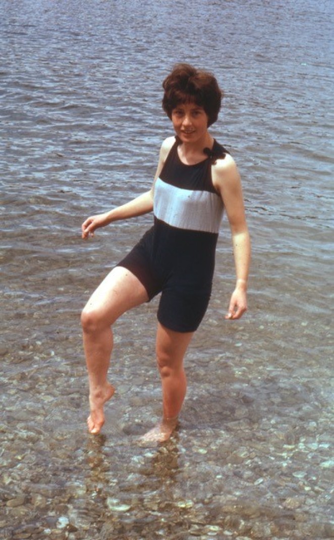 Hilary as a teenager sporting an old fashioned bathing suit dipping her toes in Lake Wakatipu during the 1962 Queenstown Centennial celebrations