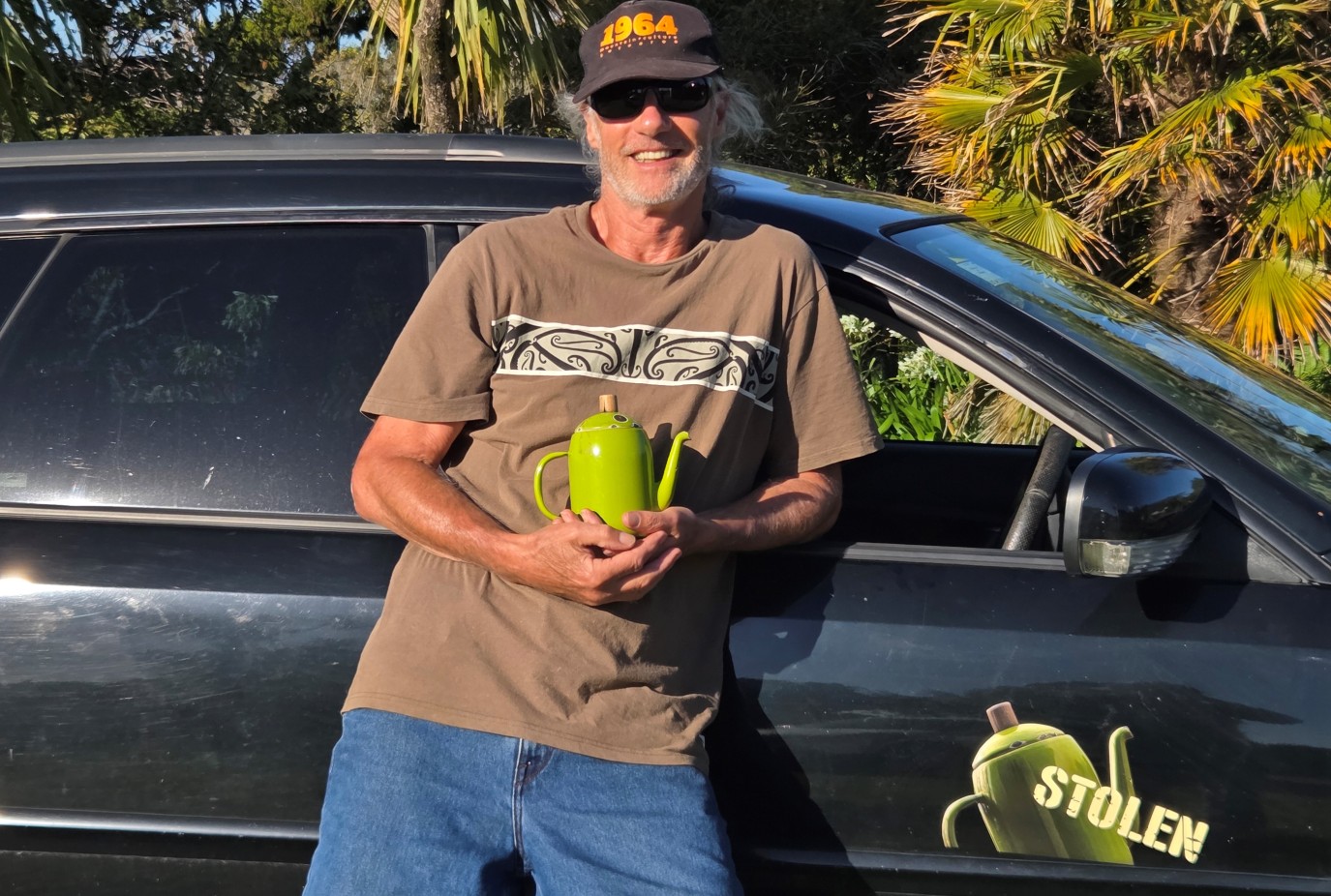 J. R. at home on the West Coast the now famous Stolen Westys Teapot now back in his possession and a focus of his art. Stolen car sticker below
