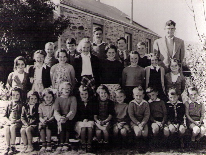 Jean second from the right in the middle row during her Ophir Blacks School photo with sole teacher Eric Bell and his 24 charges 1953