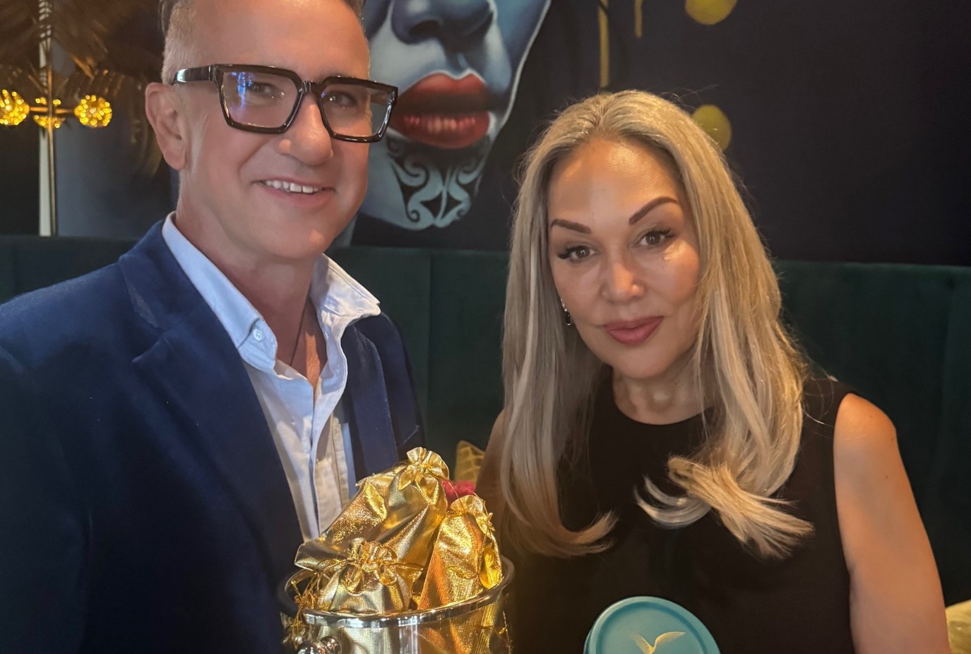 Karen right and partner John Nicolson with a drink protector and one of the gold bags they come in v2