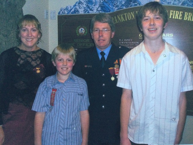Left to right Mikes wife Helen son Bryce Mike and son Jason at Mikes Gold Star presentation for 25 years service to the Frankton Fire Brigade
