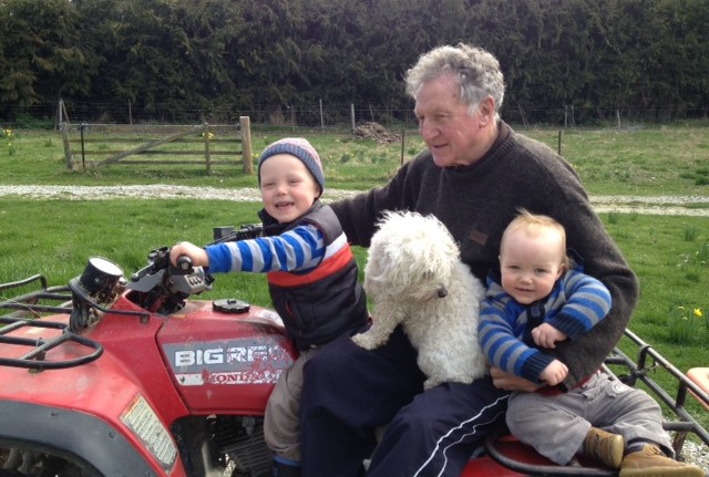 Lindsay taking grandkids Oliie left and Luca for a gentle spin on the quad bike with Teddy the dog