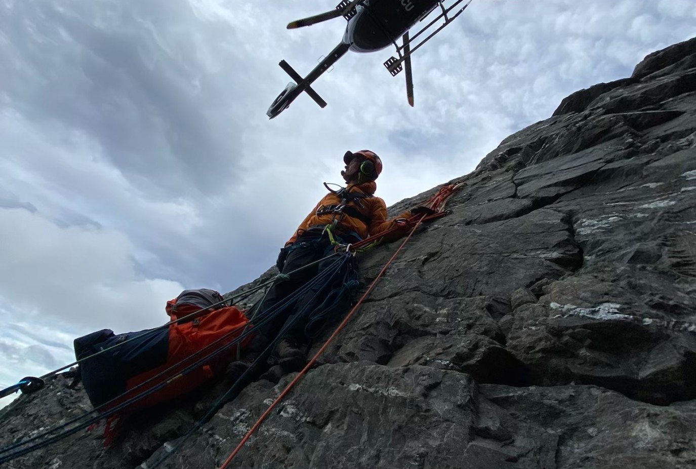 Local Alpine Cliff Rescue volunteers at work rescuing someone on a sheer face of The Remarkables Photo Wakatipu Alpine Cliff Rescue Team