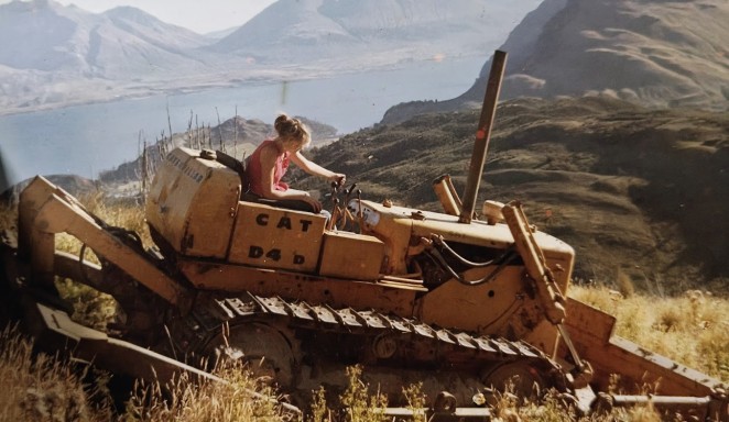 Mandy about 16 giving her dad a hand on the bulldozer above Lake Wakatipu