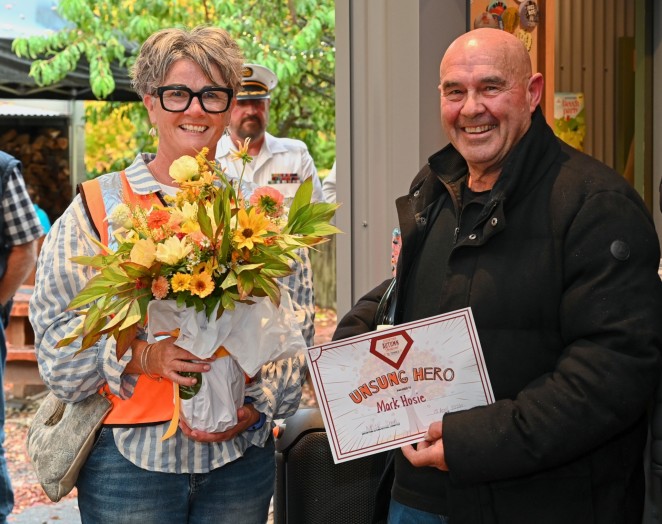 Mark right with Arrowtown Autumn Festival chairperson Nichola Bentley receiving his surprise Unsung Hero Award recently Photo Colin Walkington