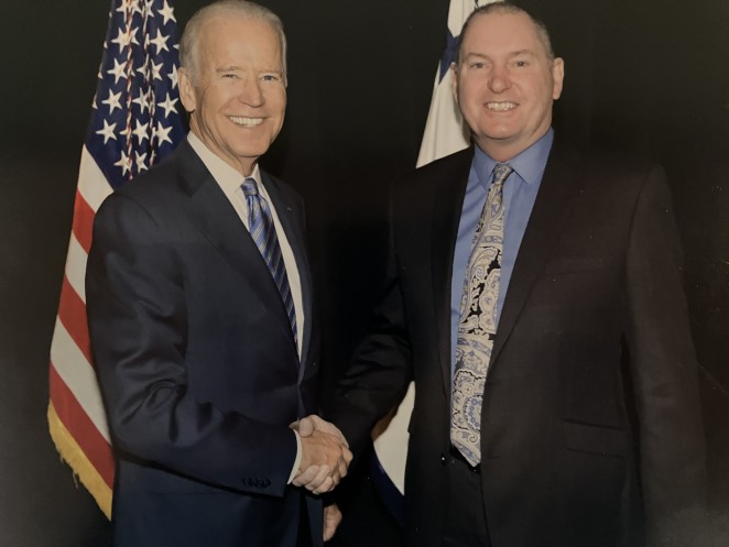 Phil right with then US Vice President Joe Biden when he ran his security during a 2015 visit 