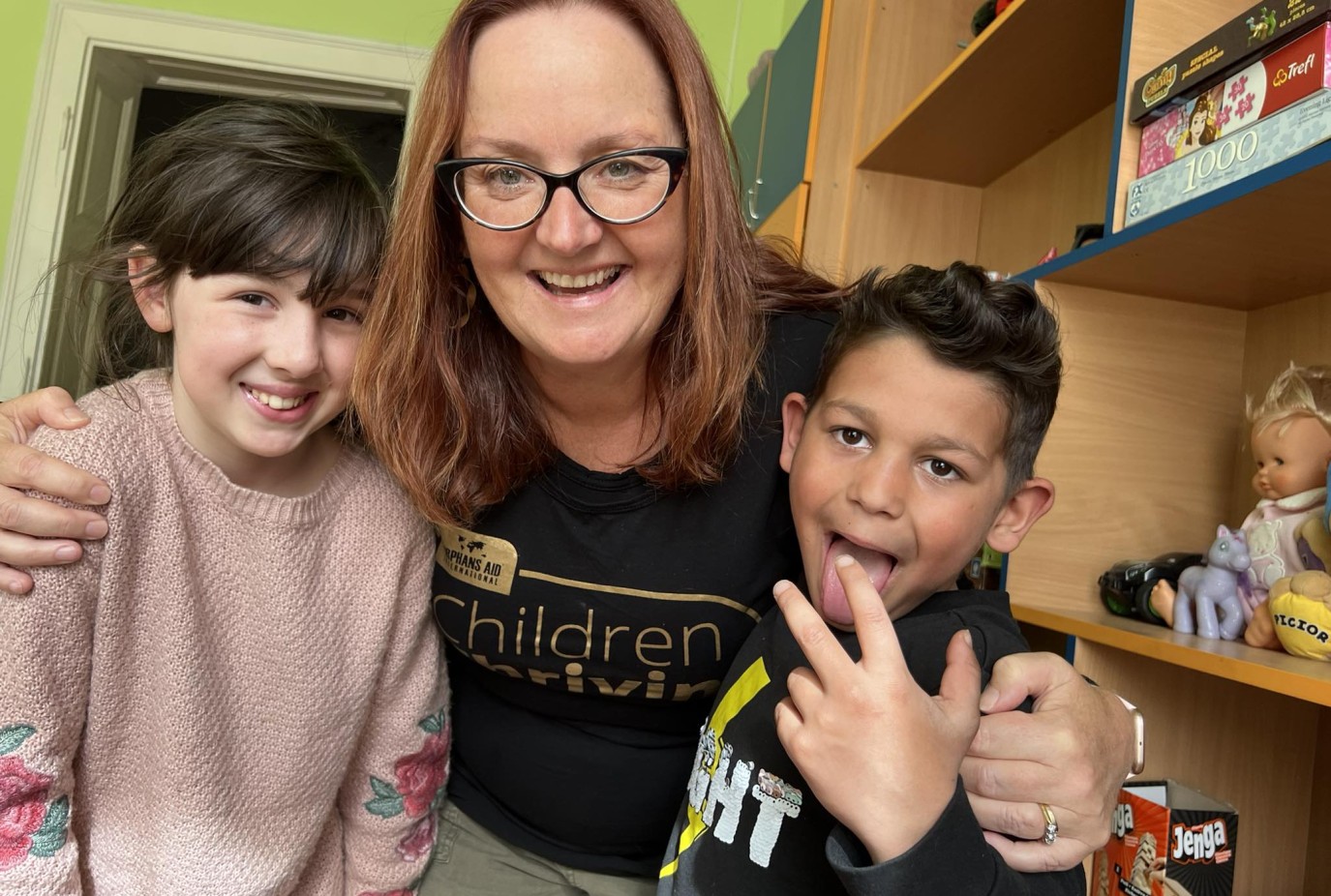 Sue with two of the kids at Orphans Aids Casa Kiwi home in Romania last year