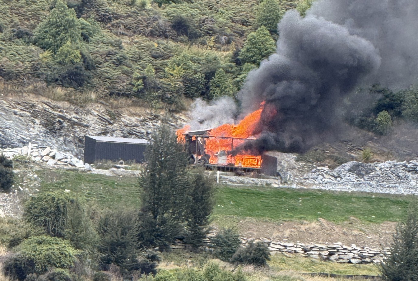 The sleepout tiny house engulfed by flames at Birley Rise off Rees Valley Road near Glenorchy yesterday 15 April