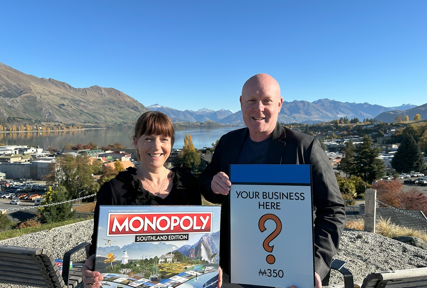 Wanaka Business Chamber chair Jo Learmonth left holding a Southland edition of the Monopoly board and Wanaka Business Chamber general manager Glenn Peat copy