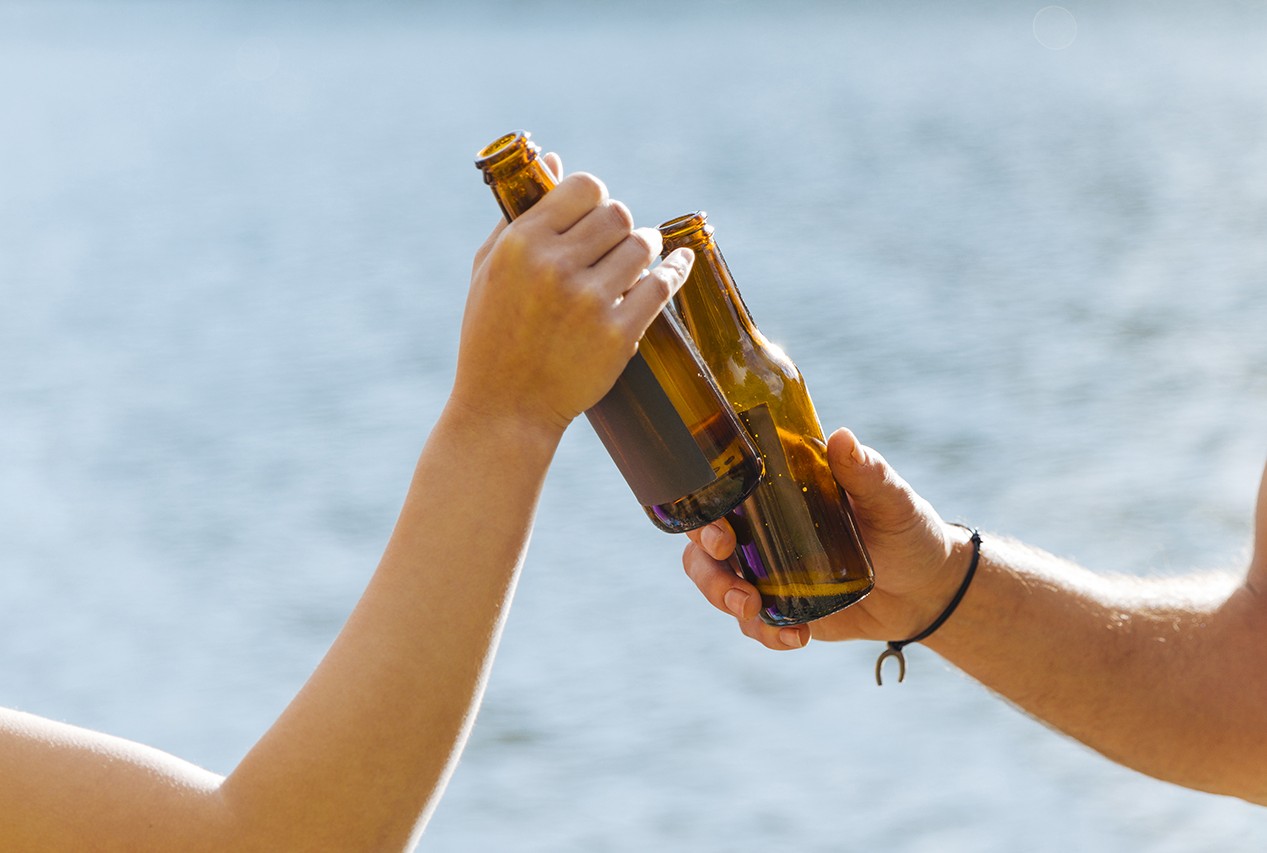 hands toasting with bottles beer copy